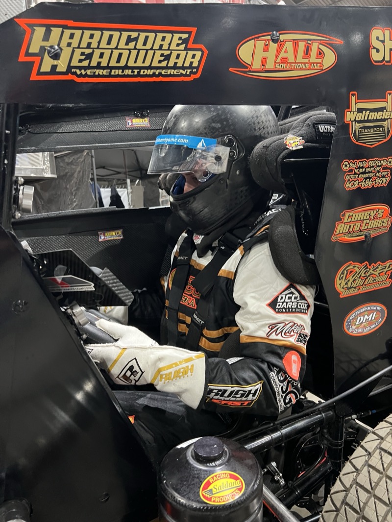 Michael Huber in the cockpit at the Chili Bowl — helmet on, strapped in